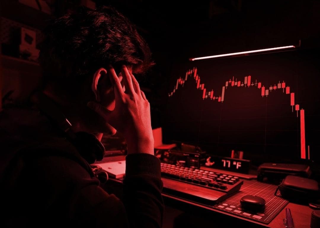 man watching his portfolio go down with crypto disaster