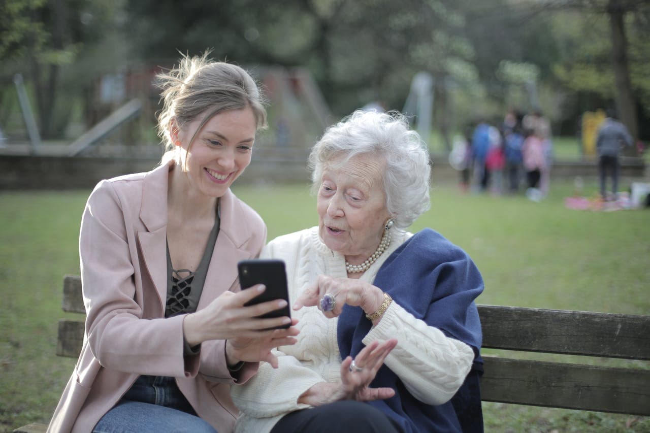 woman teaching grandmother how to identify pretexting attempts from scammers