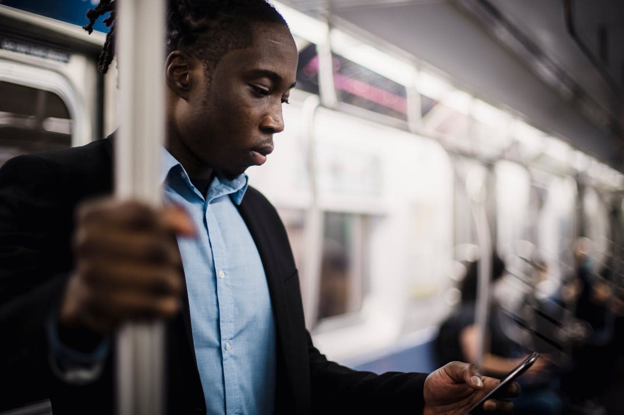 man receiving call from unknown caller while commuting to work